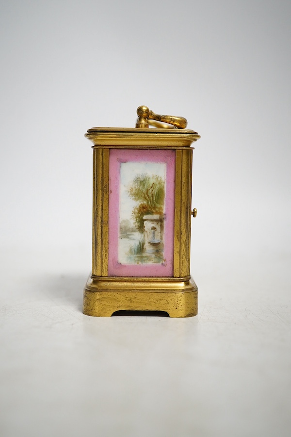 A miniature brass and enamel figurative panelled carriage timepiece, 7cm high. Condition - both gilt and enamel panels marked